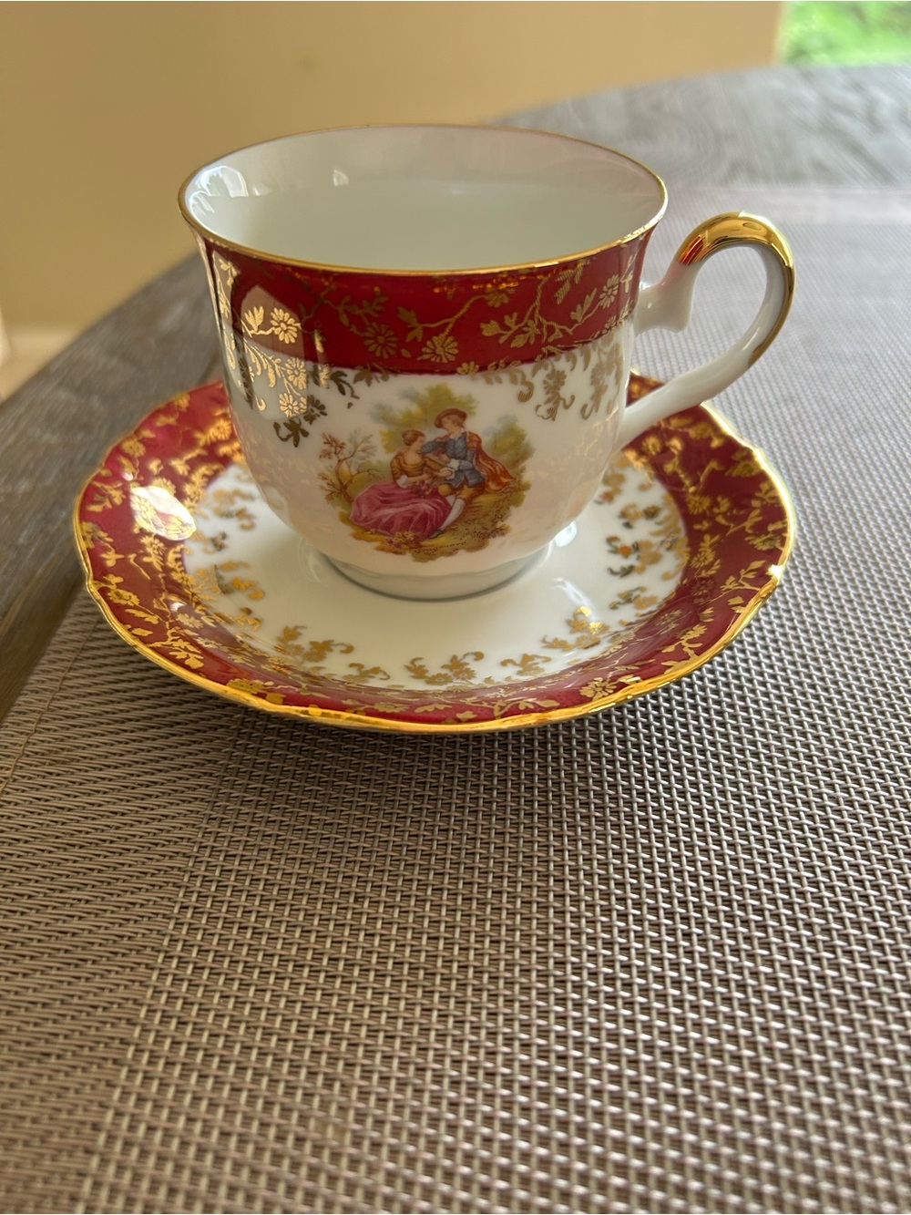 Porcelain Teacup and Saucer in Red and Gold Accent